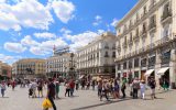 Madrid, Spain - May 31, 2015: Pedestrians walking through Puerta del Sol in Madrid, Spain. This is the very centre of Madrid and is a busy area for shopping.